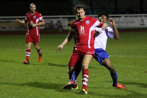 Tonbridges George Beavan (red) holds off Dernell Wynter