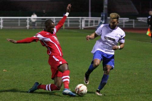 Tonbridges James Folkes (L) tackles Tyler Campbell