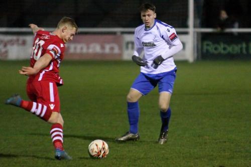 Tonbridges Luke Blewden (L) clears from Keir Dickson