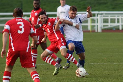 Tonbridges Nick Wheeler (red) challenges Billy Crook