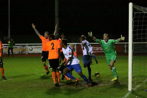 Billericay appeal unsuccessfully for offside against Harold Joseph (white, R) who also looks unsure of the goals legality