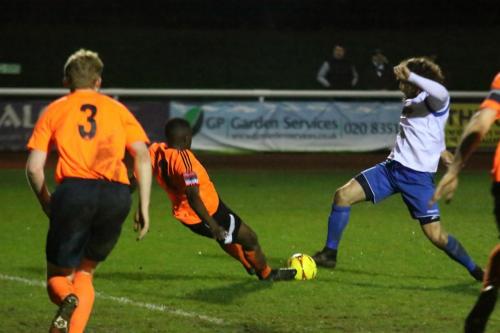 Billericays Abs Seymour (orange) tackles Harry Ottaway at full stretch