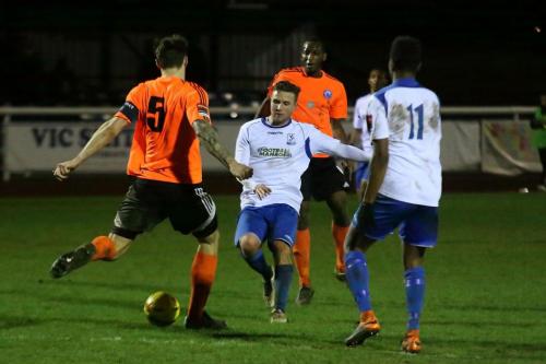 Billericays Rob Swaine (L) clears from Billy Crook
