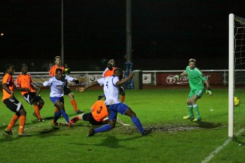 Enfields Harold Joseph (4) is played onside by a Billericay defender (orange socks) before scoring Enfields first goal