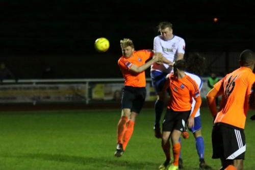 Enfields Mark Kirby (white) wins a header against Danny Fitzsimons