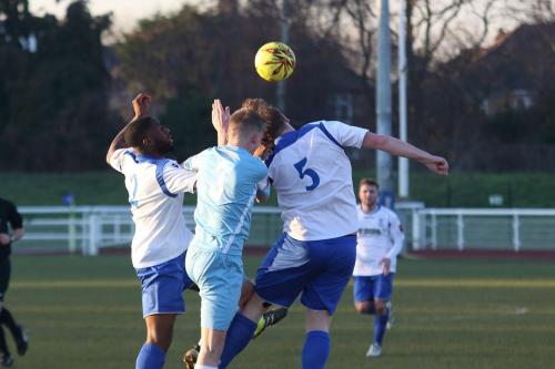 Enfields Harold Joseph (L) and Mark Kirby challenge Joe Payne