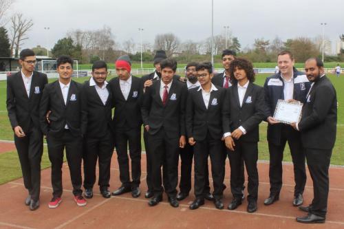 Chairman Paul Reed (2nd R) makes a presentation to the Enfield Town India team