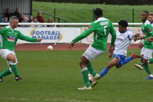 Enfields Dernell Wynter drives a shot from outside the box, bringing a fine save from keeper Louis Wells