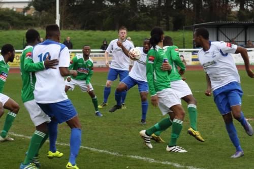 Enfields Harold Joseph (white, 2nd R) cant make contact with a bouncing ball