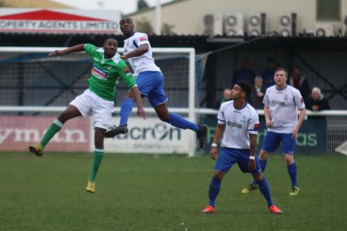 Enfields Harold Joseph heads clear from Daniel Carr