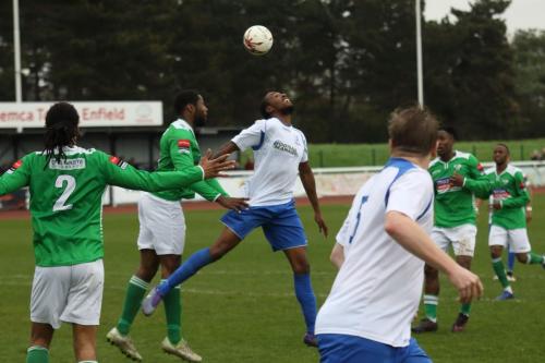 Enfields Ricky Gabriel (white, L) challenges for the ball at a corner