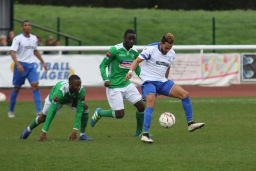 Enfields Tyler Campbell (R) pursued by DSean Theobalds (L) and Paul Semakula