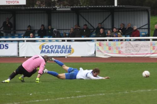 Leatherhead Louis Wells, caught in possession outside the penalty area by Mickey Parcell, brings Parcell down to earn a yellow card