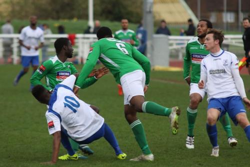 Leatherheads Jerry Nnamani (6) heads clear from Karl Oliyide (10) and Mickey Parcell