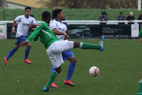 Leatherheads Paul Semakula (green) clears from Dernell Wynter