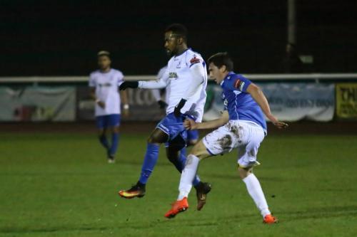 Lowestofts Travis Cole (R) clears from Bobby Devyne