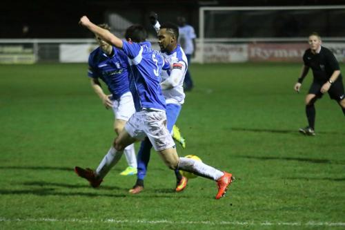 Lowestofts Travis Cole (blue shirt) blocks Bobby Devynes attempt to get past