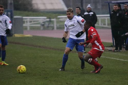 Enfields Blake Thompson (white), making his debut as a substitute, plays the ball past Alex Addai