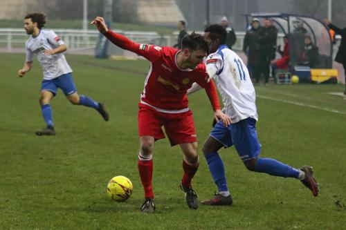 Enfields Bobby Devyne (R) turns inside Simon Cooper