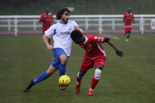 Enfields Harry Ottaway (L) cuts inside Kershaney Samuels