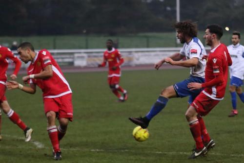 Enfields Harry Ottaway sees his shot charged down by Tutu Henriques (L)