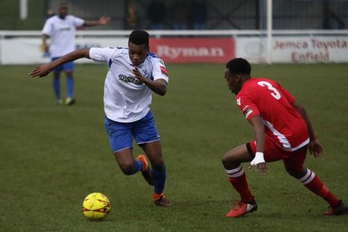 Enfields Karl Oliyide (L) and Mersthams Kristian Campbell