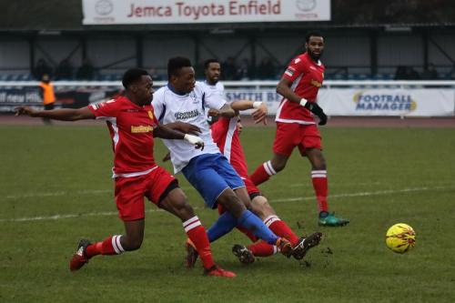 Enfields Karl Oliyide shoots undeer pressure from Kristian Campbell (L) and Tutu Henriques