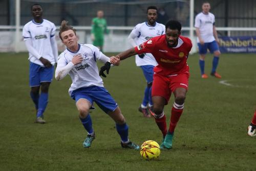 Enfields Mickey Parcell (L) bounces off the challenge of Marc Okoye