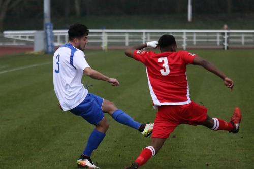 Enfields Samir Bihmoutine (L) gets his cross in as Kristain Campbell tries to block
