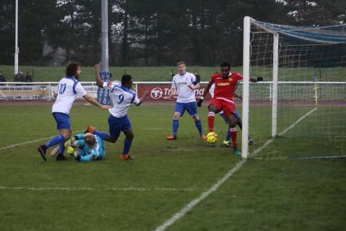 Marc Okoye clears Karl Oliyides (9) shot off the Merstham line