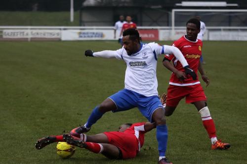 Mersthams Kristain Campbell tackles Bobby Devyne as Kershaney Samuels looks on