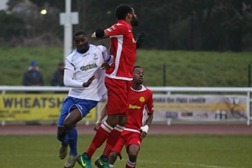 Mersthams Marc Okoye (red) heads clear from Percy Kiangebeni