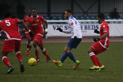 Scott Shulton tries to thread a pass through the defence as Enfield chase a late equaliser