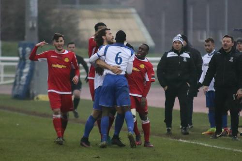 Tempers flare briefly resulting in a yellow card for Enfields Percy Kiangebeni (6)