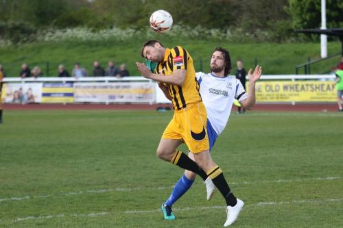 Enfields Harry Ottaway is penalised for a high foot against Liam Friend