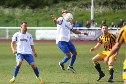 Enfields Tyler Campbell chests the ball down watched by Scott Shulton (L) and Miles Cornwell