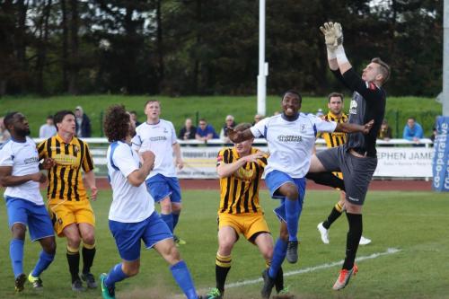 Folkestone keeper Tim Roberts comes out to collect the ball ahead of Ricky Gabriel