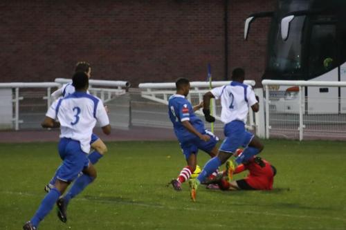 Enfield keeper Nathan McDonald brings down Reece Dobson to concede a penalty