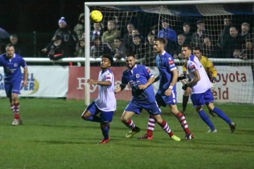 Enfields Dernell Wynter (white, L) tries to reach a clearance