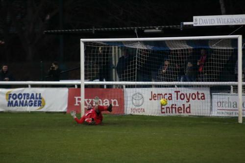 Enfields Nathan McDonald is beaten by Callum Harrisons penalty to make the score 1-1