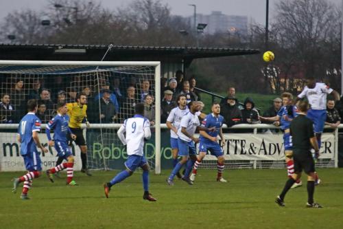 Enfields Percy Kiangebeni (R) heads across goal