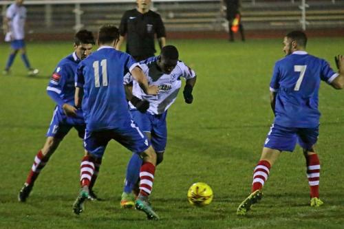 Enfields Percy Kiangebeni wriggles between Kem Izzet (L), Darryl Coakley and Luke Ingram (7)