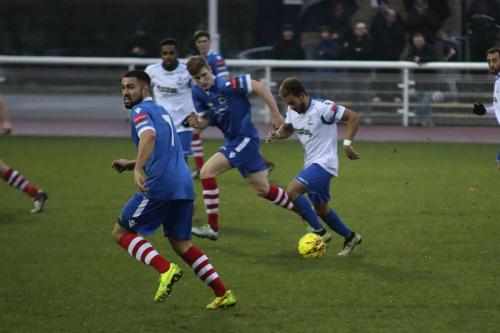 Enfields Tyler Campbell runs at the defence  Luke Ingram checks the left wing