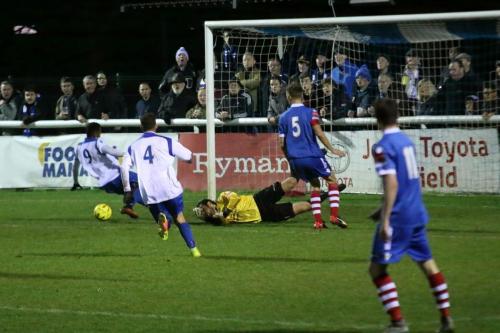 Im not sure if Needham keeper Danny Gay got a touch to this cross but it went behind Bobby Devyne (9)