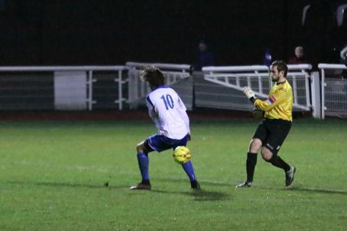 Needham keeepr Danny Gay just misses Harry Ottaway with his clearance