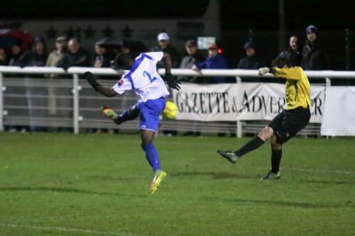 Needham keeper Danny Gay just misses Percy Kiangebeni with a clearance