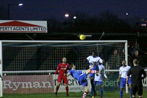 Needhams Darryl Coakley (blue) and Enfields Percy Kiangebeni challenge for a loose ball
