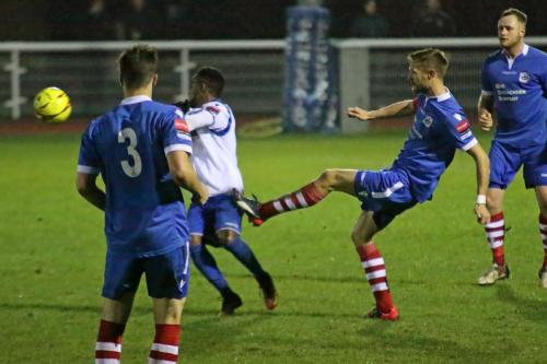Needhams Ian Miller (R) clears from Bobby Devyne