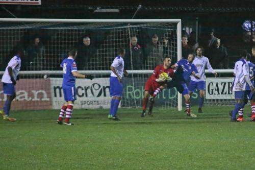 Needhams Sam Nunn challenges Enfield keeper Nathan McDonald