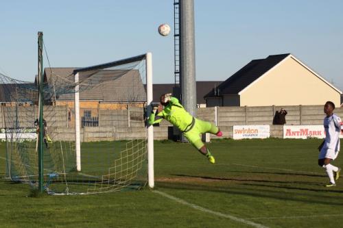 Grays keeper Amadou Tangara tips a shot round the post as Trey Williams waits for a possible rebound
